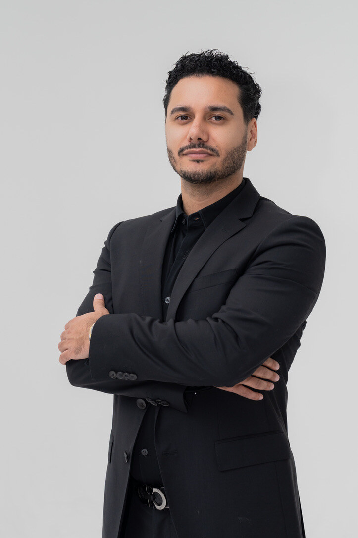 Danny Nabavi in a black suit with his arms crossed